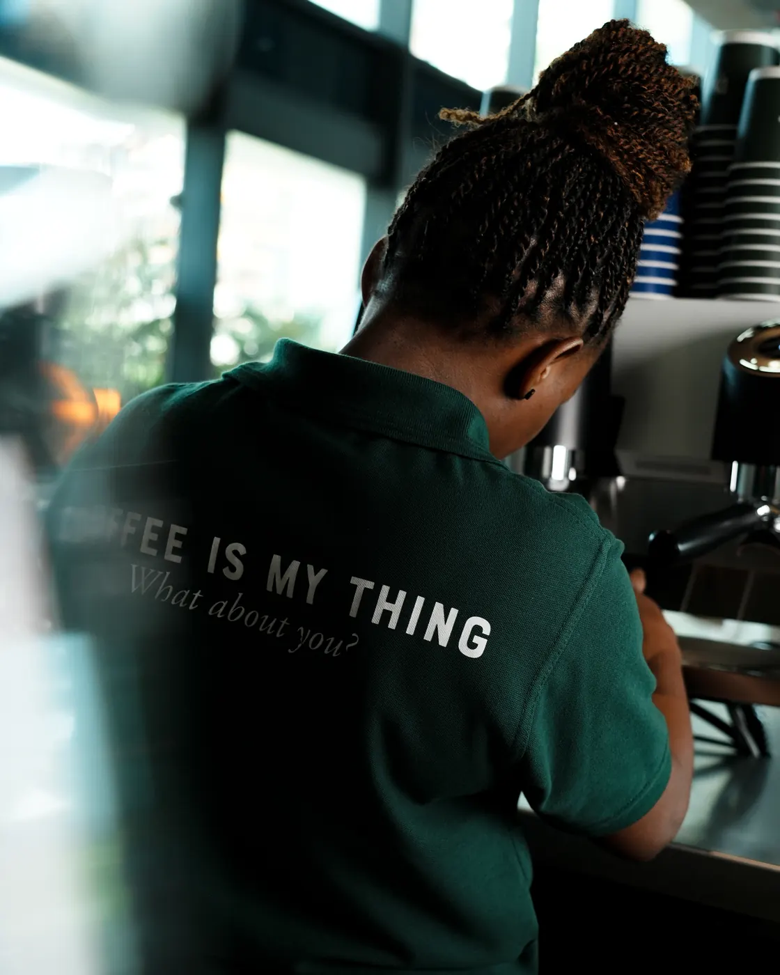 DS Café barista at the counter in a Coffee is my thing tee