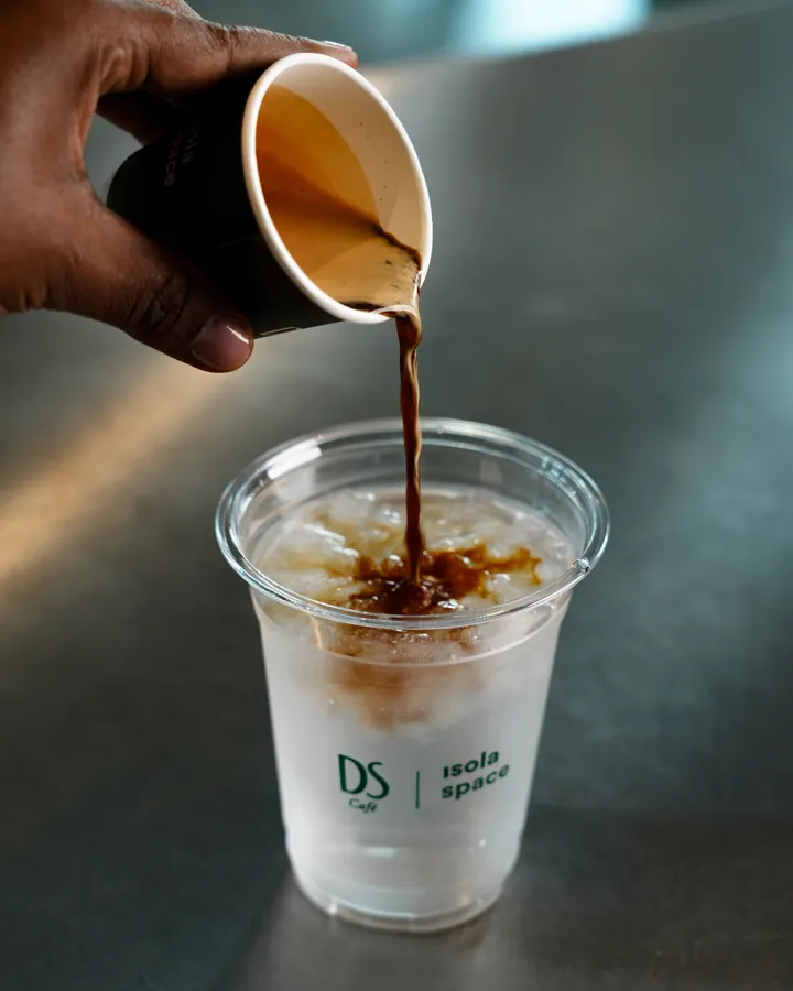 Espresso poured into an iced coffee